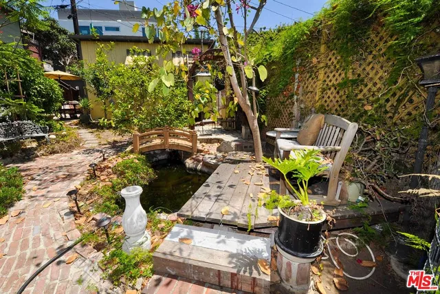 a view of a backyard with sitting area and garden