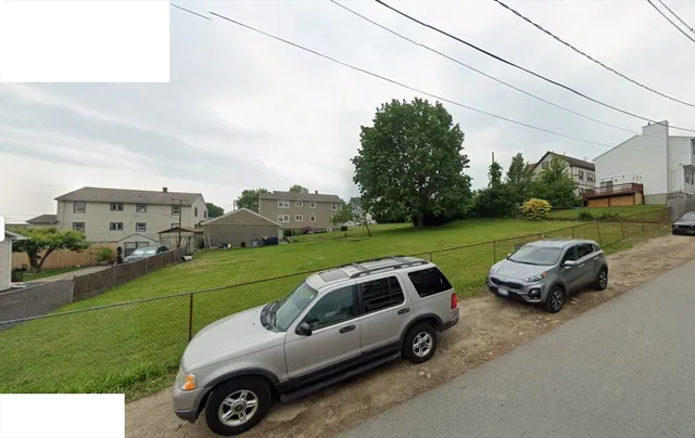 a view of a yard with furniture and a garden