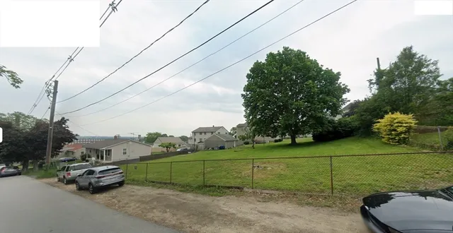 a view of a road with a bench in front of it