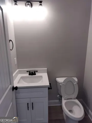 a bathroom with a toilet a sink and mirror