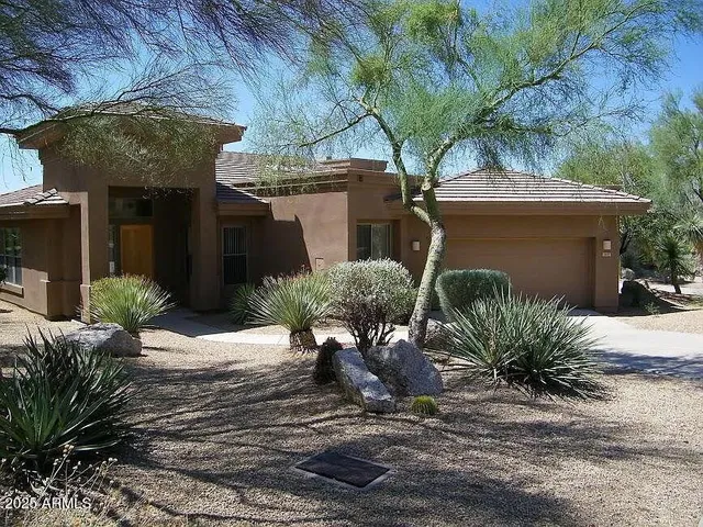 a view of a backyard with plants and patio