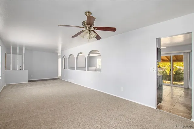 a view of a livingroom with a ceiling fan and window
