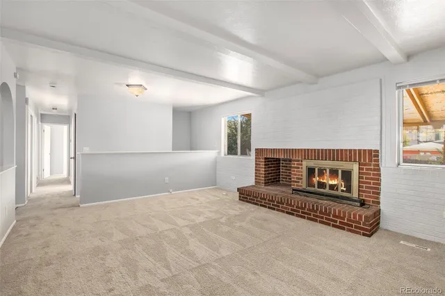 a view of an empty room and a window