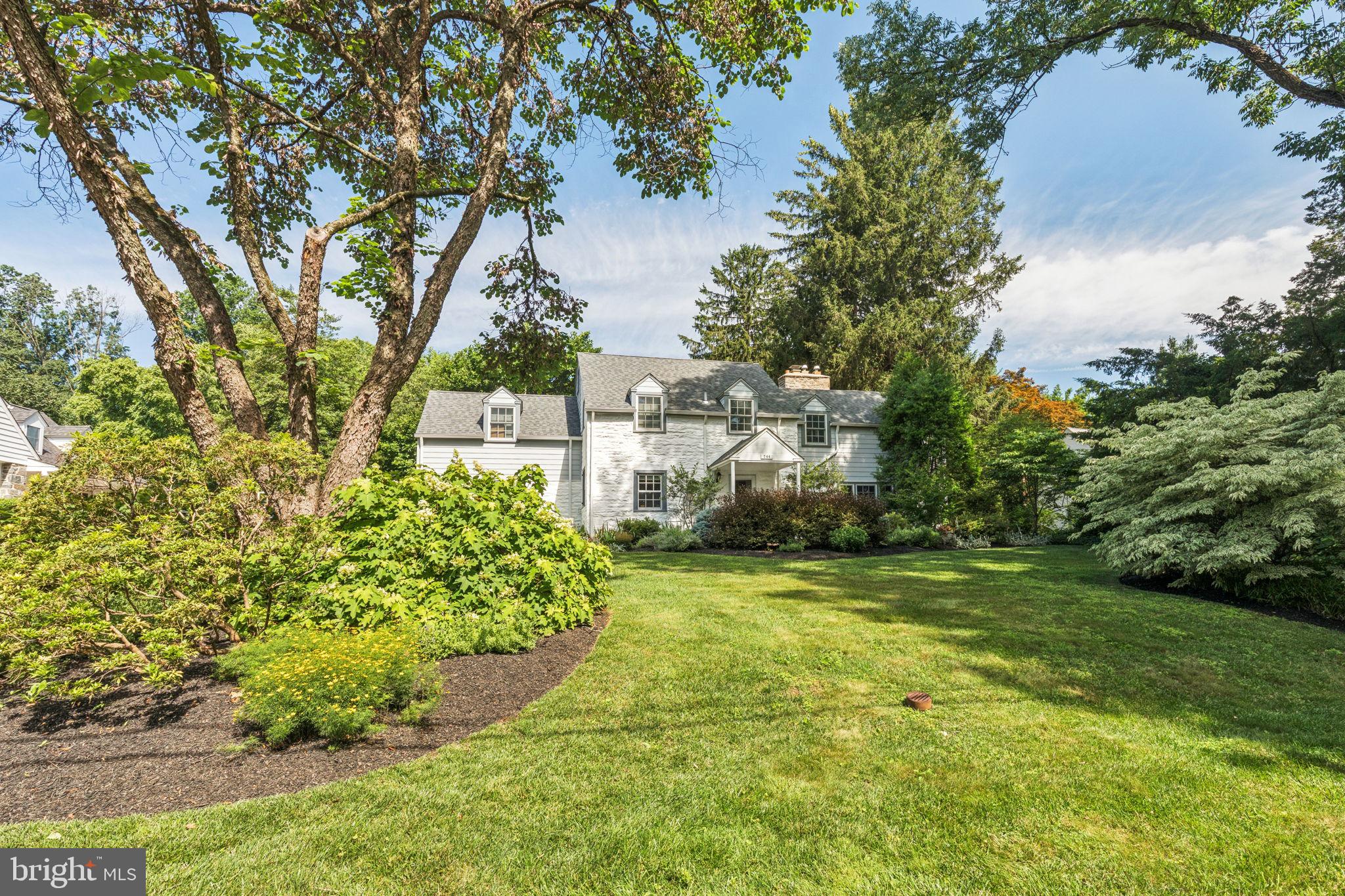a view of a garden with a building in the background