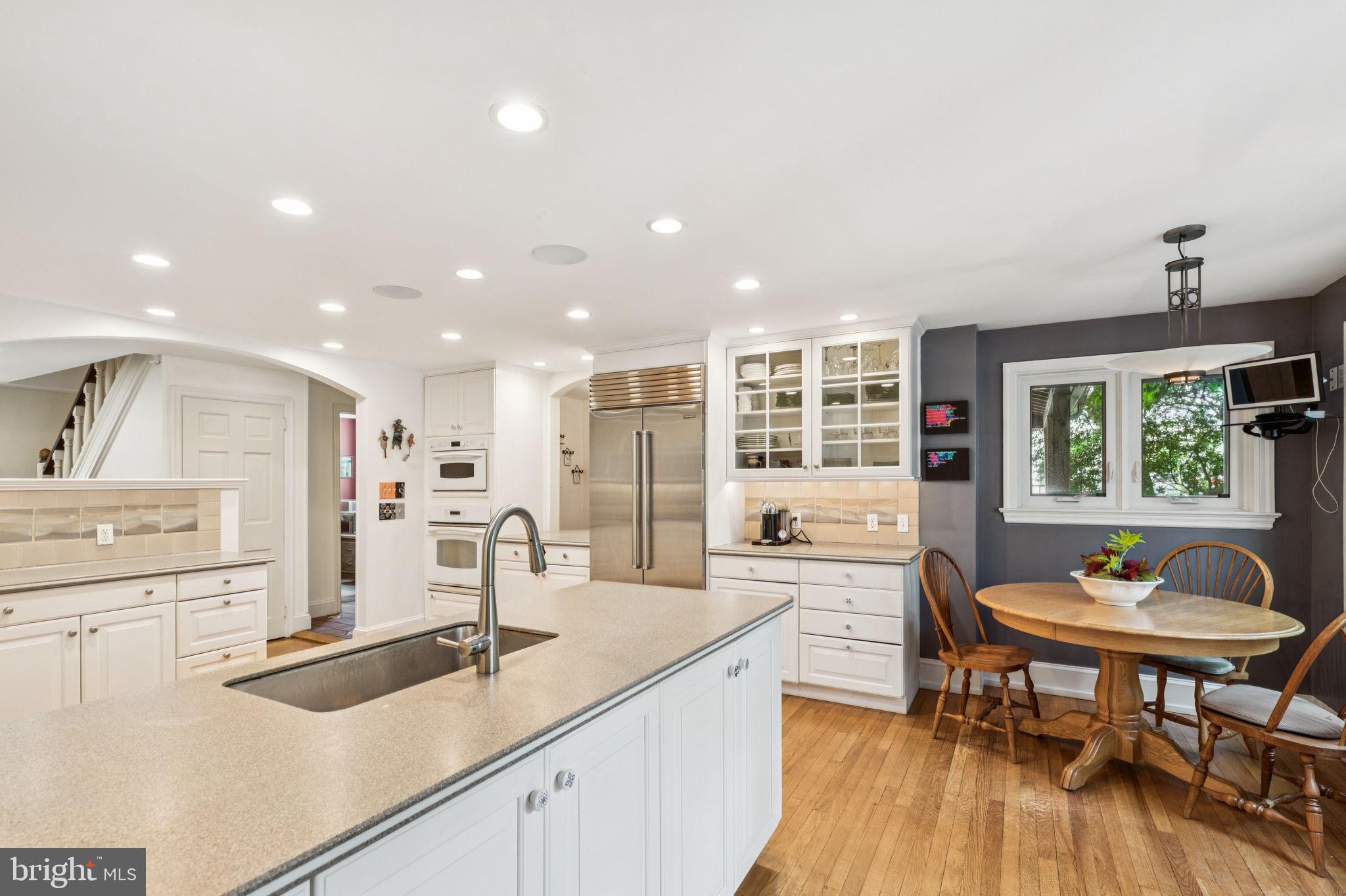744 Clarendon Road Penn Valley, PA 19072 - Photo 11 of 41 a kitchen with stainless steel appliances granite countertop sink stove and wooden floor
