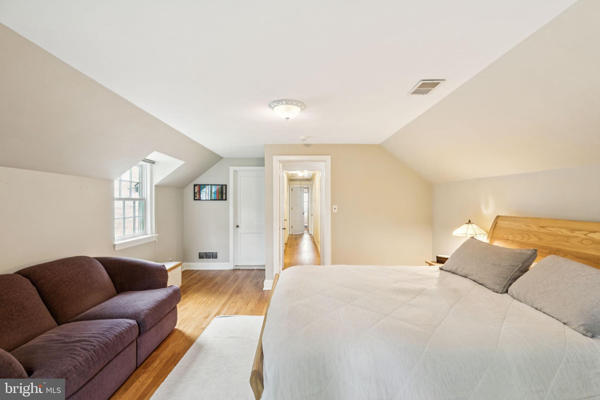 744 Clarendon Road Penn Valley, PA 19072 - Photo 29 of 41 a bed room with a bed and a couch