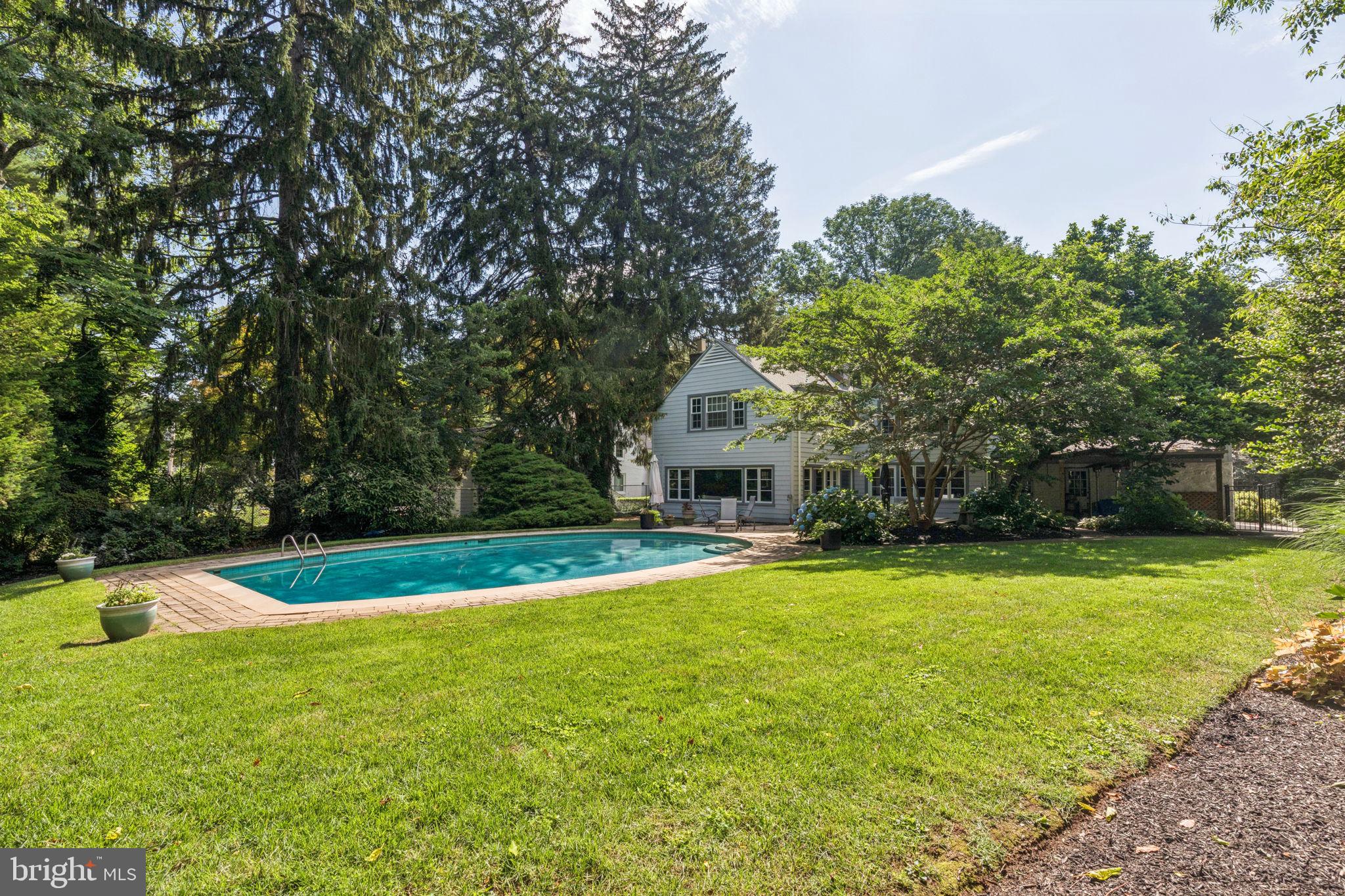 744 Clarendon Road Penn Valley, PA 19072 - Photo 3 of 41 a view of a house with swimming pool and a yard