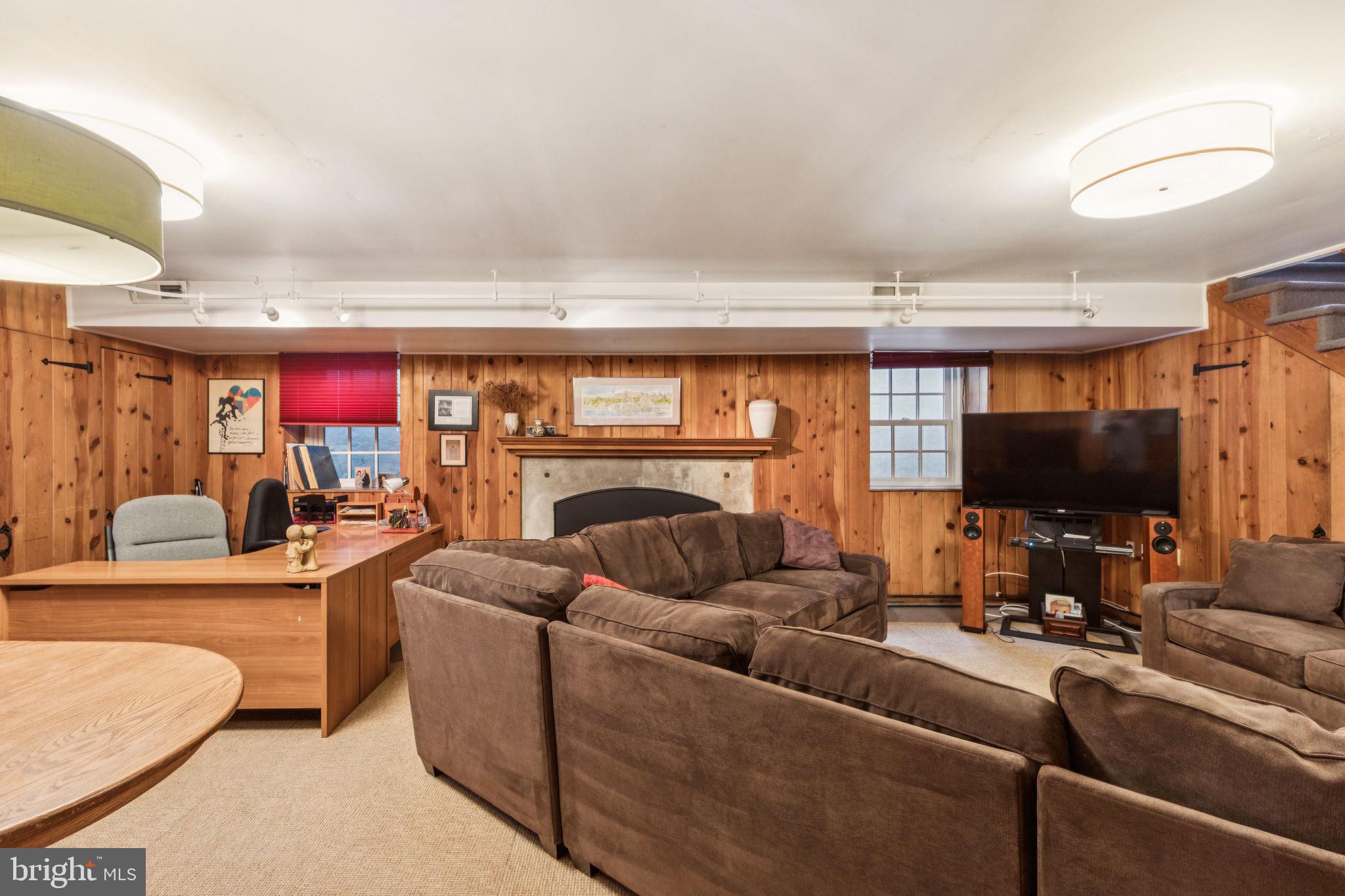 744 Clarendon Road Penn Valley, PA 19072 - Photo 38 of 41 a living room with furniture and a flat screen tv