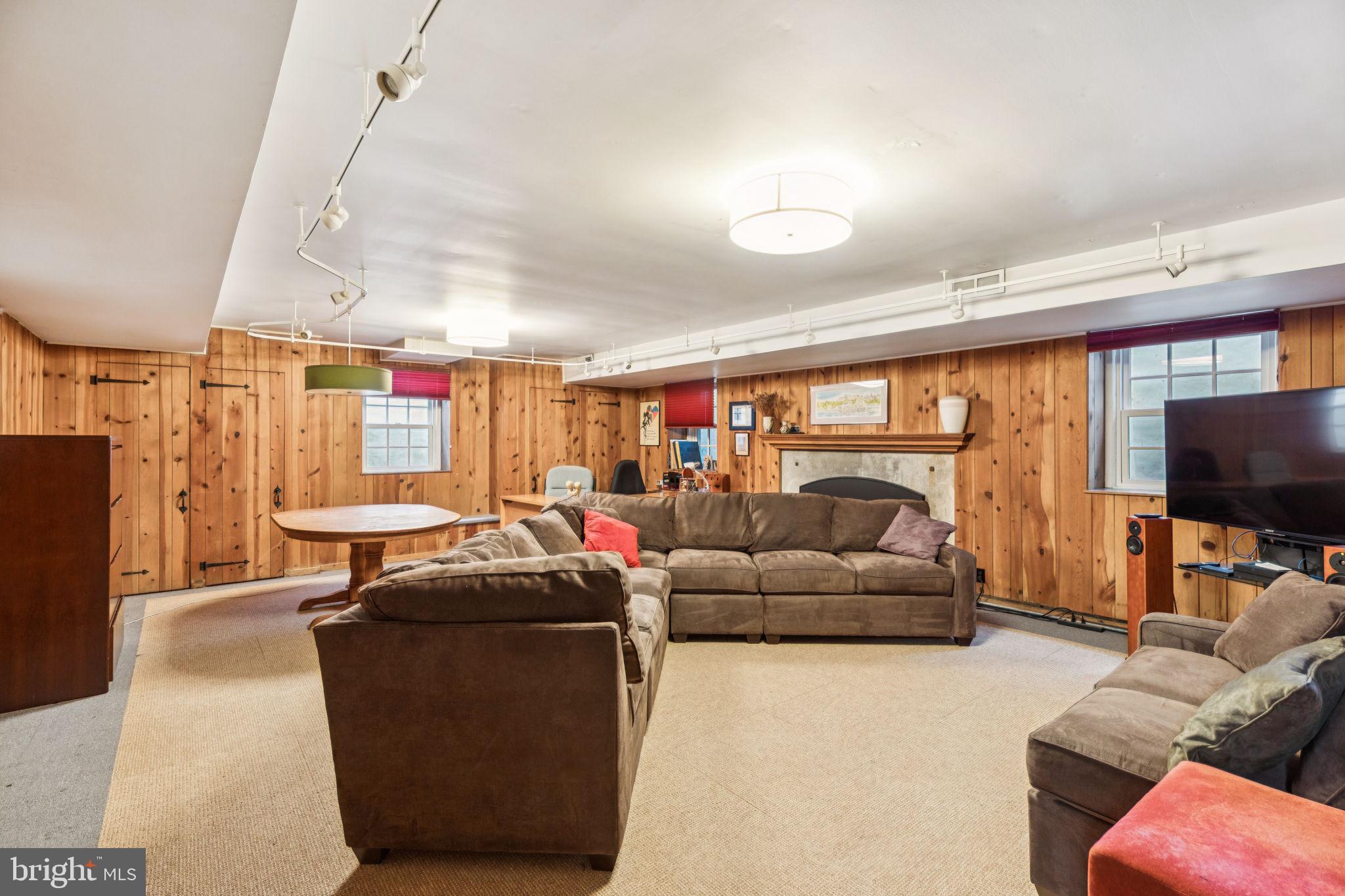 744 Clarendon Road Penn Valley, PA 19072 - Photo 39 of 41 a living room with furniture a flat screen tv and a large window