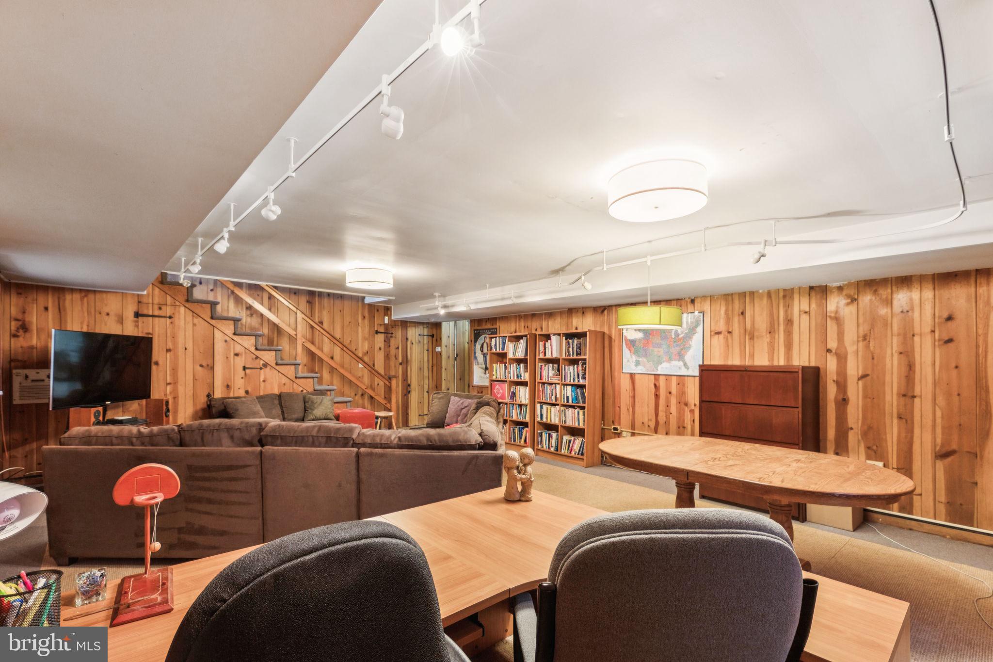 744 Clarendon Road Penn Valley, PA 19072 - Photo 40 of 41 a living room with furniture a flat screen tv and a large window