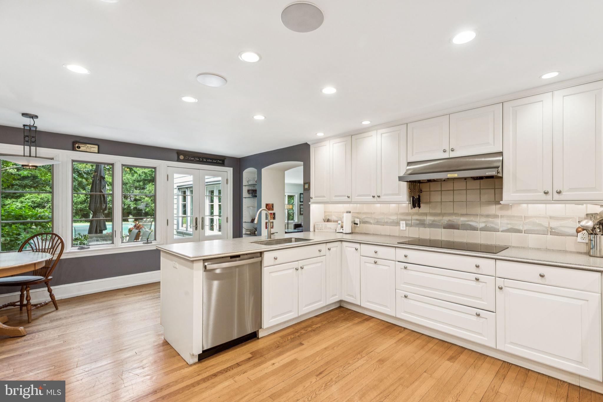 744 Clarendon Road Penn Valley, PA 19072 - Photo 8 of 41 a kitchen with granite countertop white cabinets and white appliances