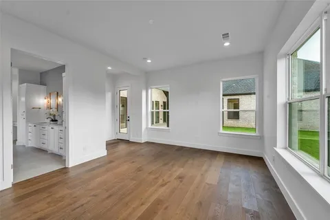 a bedroom with a bed and a large mirror