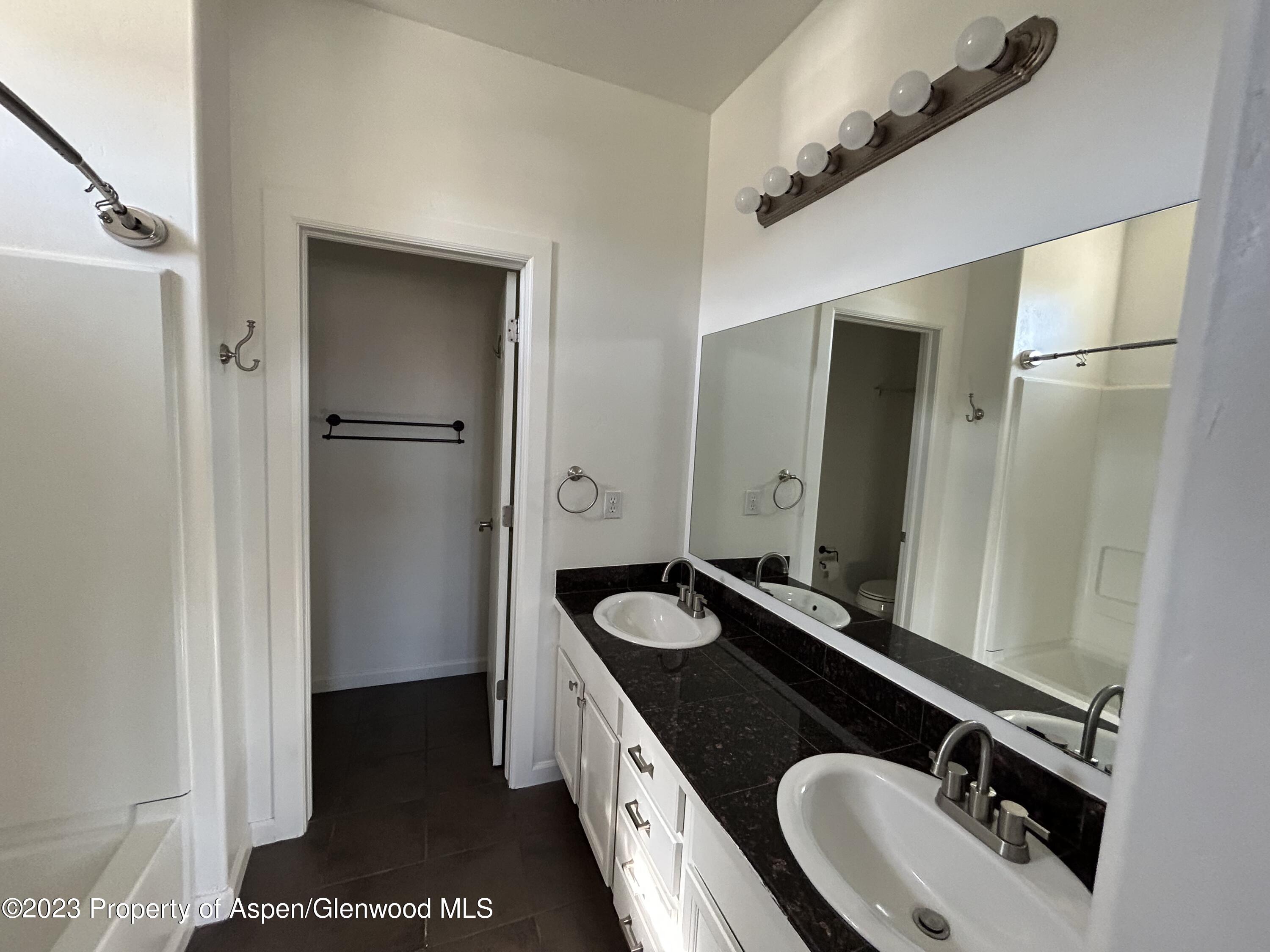 710 West 24th Street Rifle, CO 81650 - Photo 14 of 19 a bathroom with a sink and a mirror