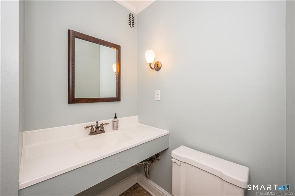 50 Glenbrook Road, Unit 6E Stamford, CT 06902 - Photo 16 of 18 a bathroom with a toilet a sink and mirror