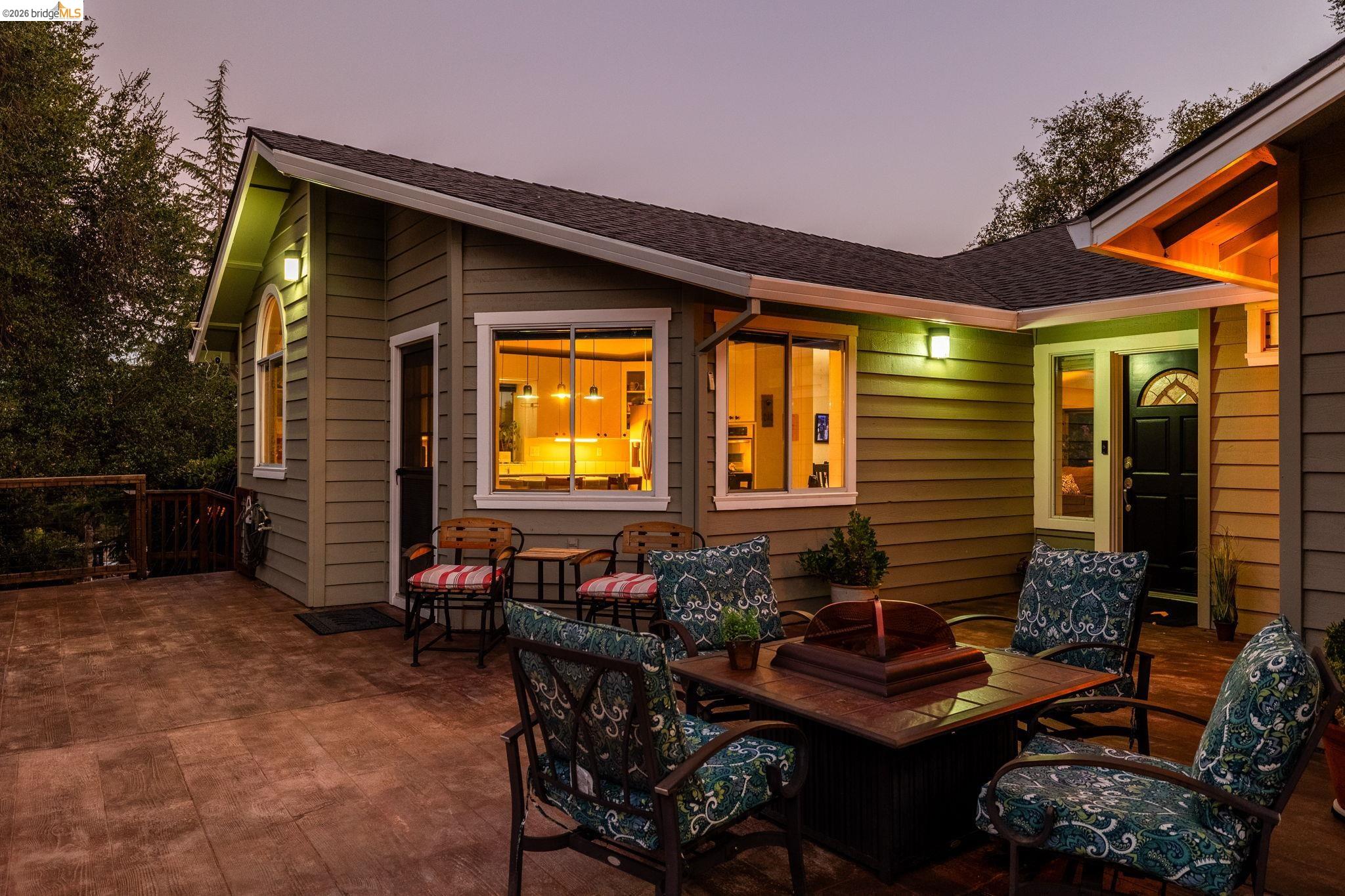 18570 Pradera Real Road Sonora, CA 95370 - Photo 8 of 66 Inviting front patio with exterior ighting, offering a comfortable space to enjoy the evening ambiance.