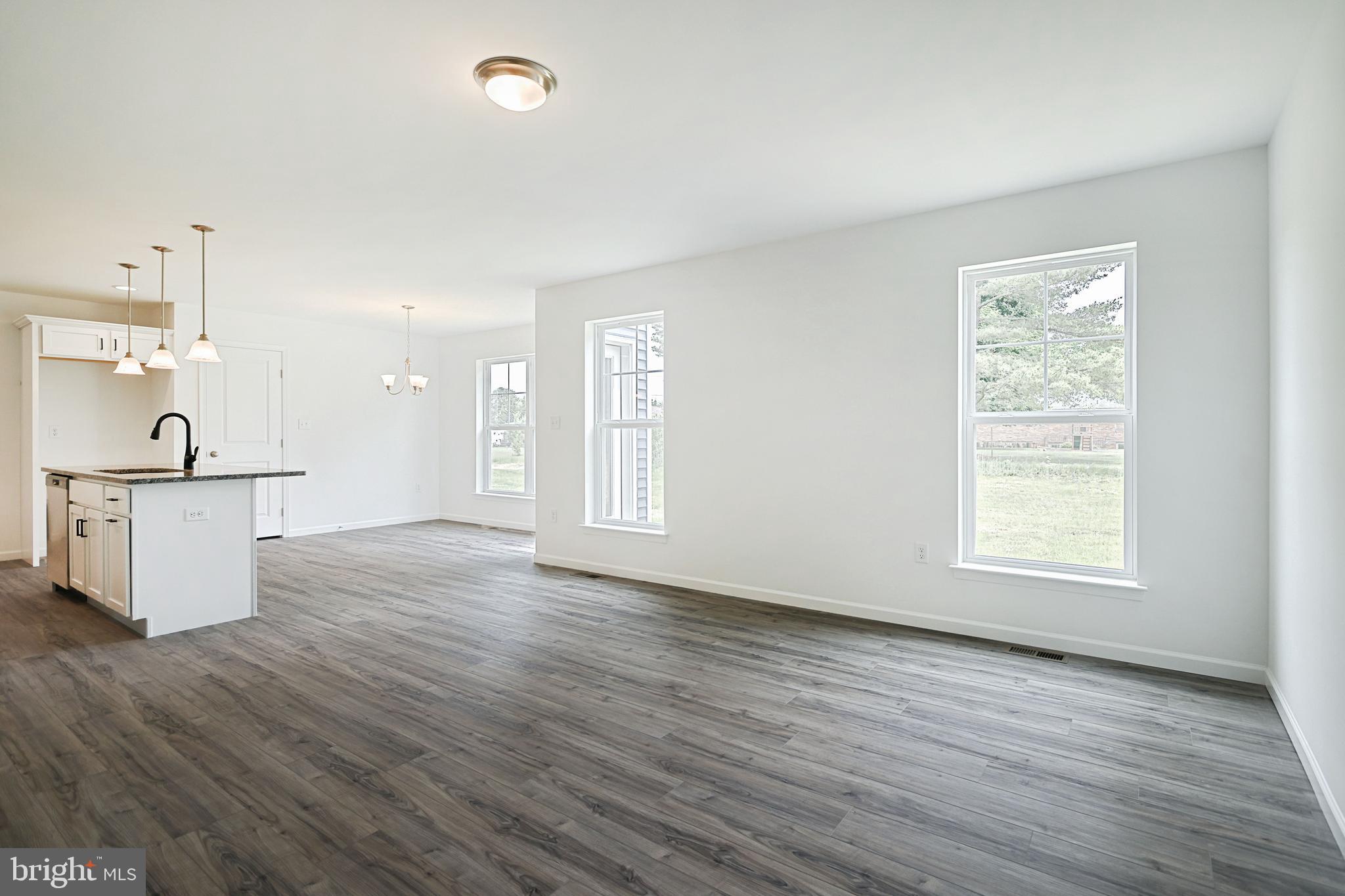 Meriwether Plan At Stone Mill Estates Duncannon, PA 17020 - Photo 11 of 28 an empty room with wooden floor and windows