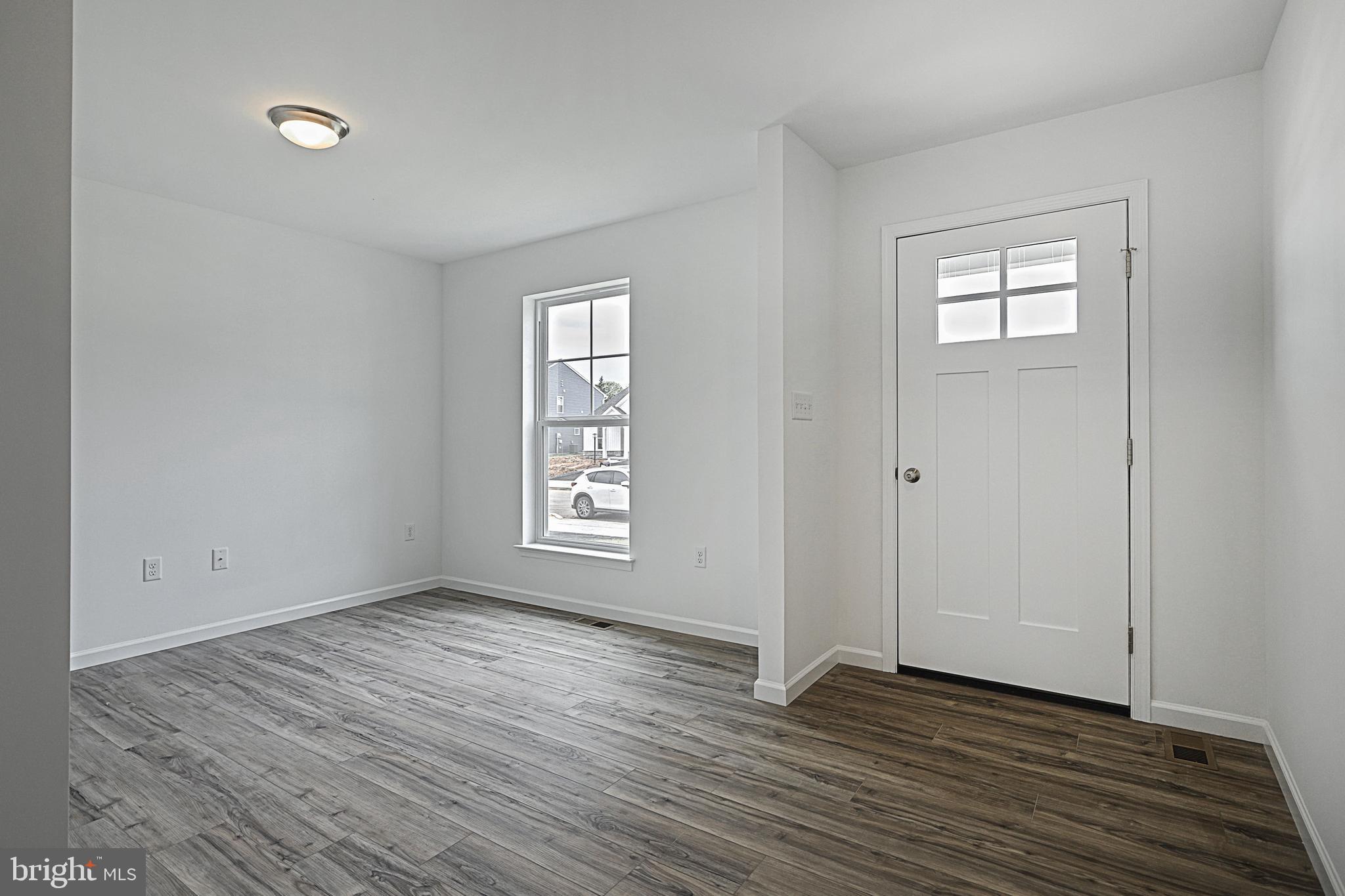 Meriwether Plan At Stone Mill Estates Duncannon, PA 17020 - Photo 13 of 28 a view of an empty room with wooden floor and a window