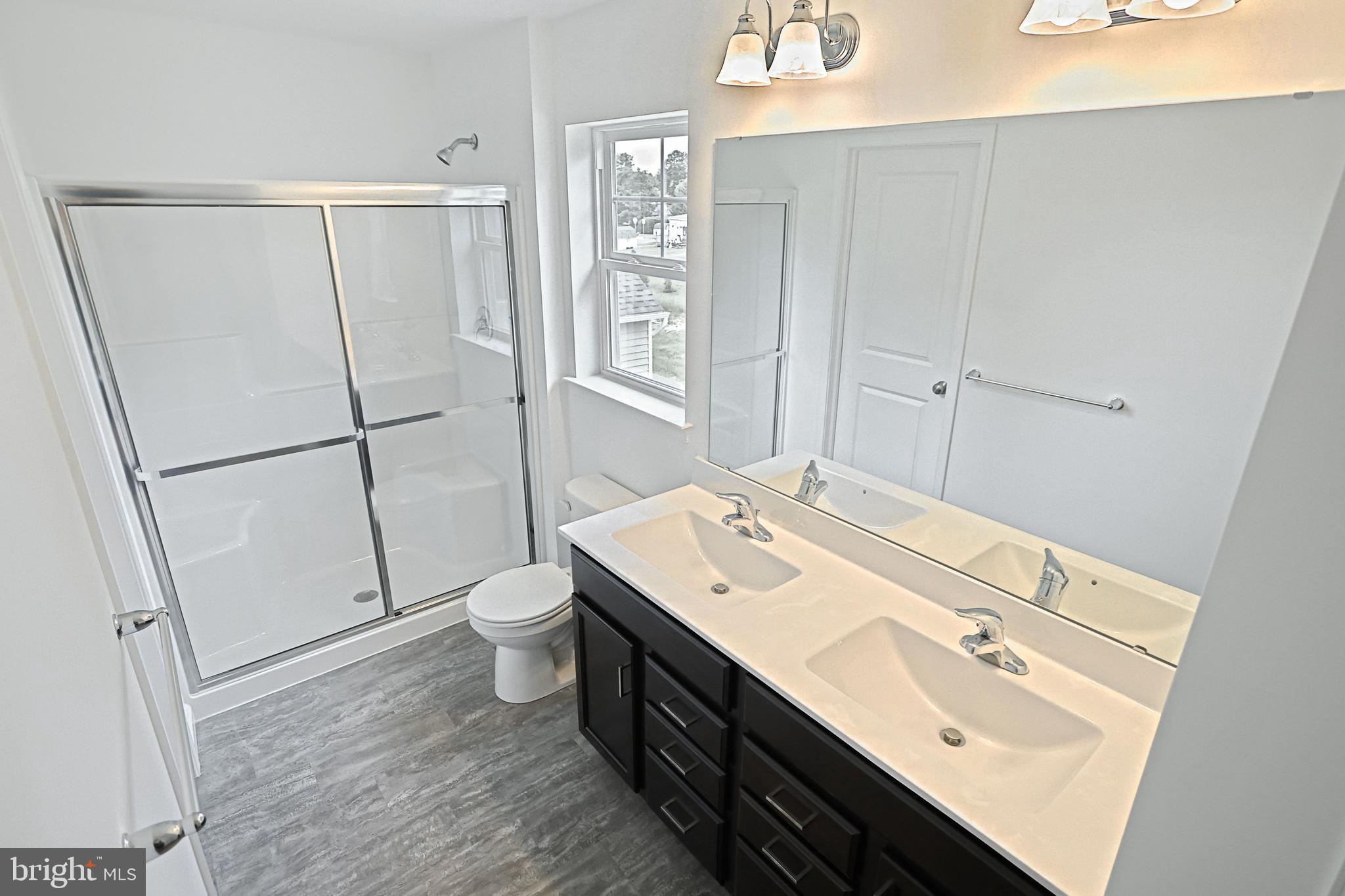 Meriwether Plan At Stone Mill Estates Duncannon, PA 17020 - Photo 20 of 28 a bathroom with a double vanity sink toilet and mirror