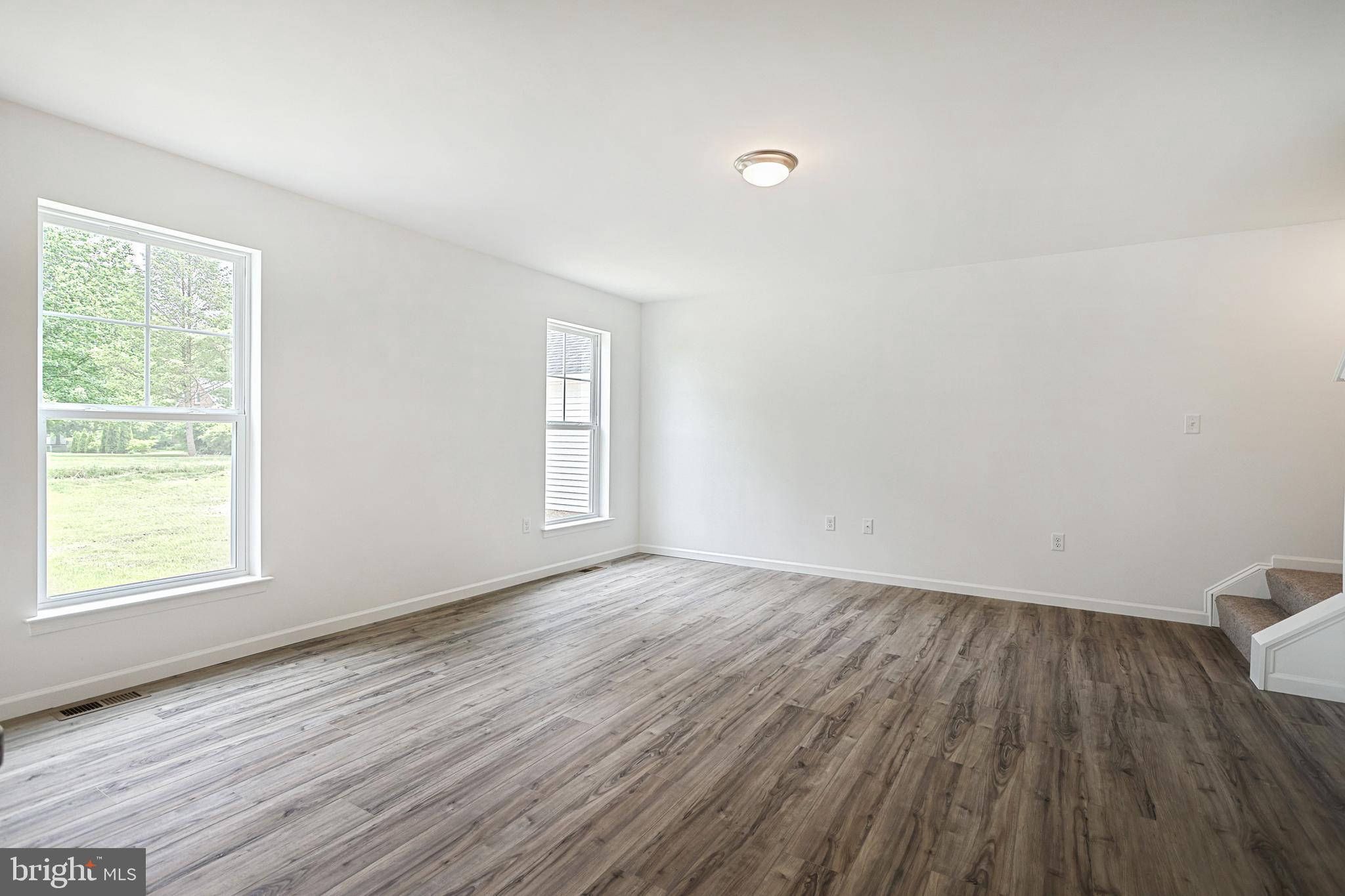 Meriwether Plan At Stone Mill Estates Duncannon, PA 17020 - Photo 9 of 28 an empty room with wooden floor and windows