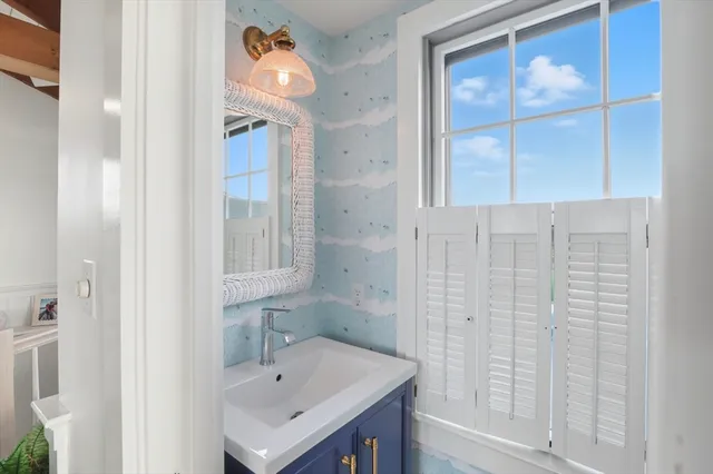 a bathroom with a sink a vanity and a shower