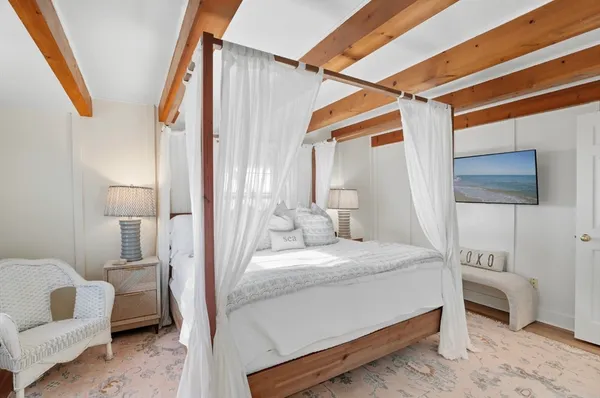 a bedroom with a bed a couch and dresser