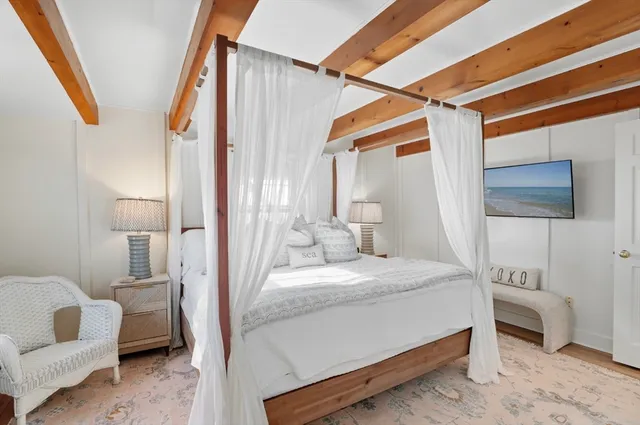 a bedroom with a bed a couch and dresser