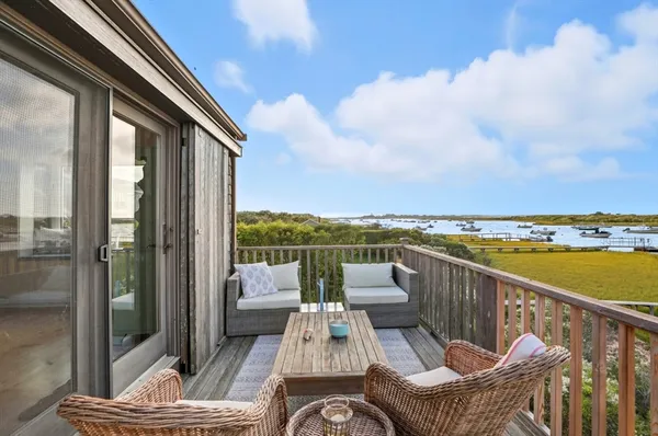 a view of a balcony with chair and wooden floor