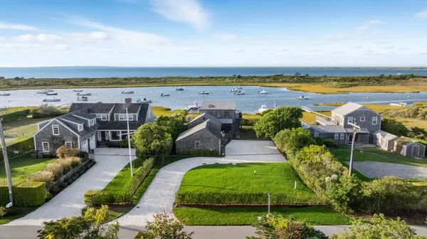 an aerial view of a house with outdoor space swimming pool and ocean view