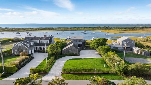 an aerial view of a house with outdoor space swimming pool and ocean view