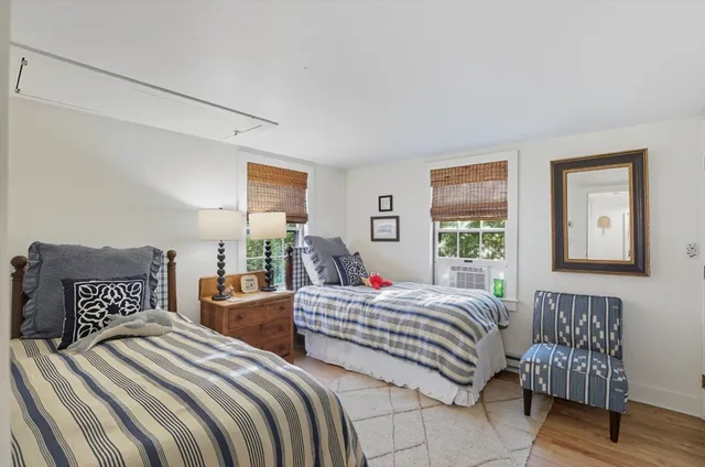 a bedroom with two beds and a window