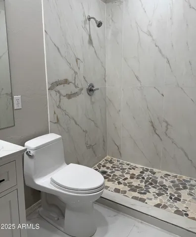 a white toilet sitting next to a shower curtain