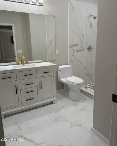 a bathroom with a toilet sink and mirror