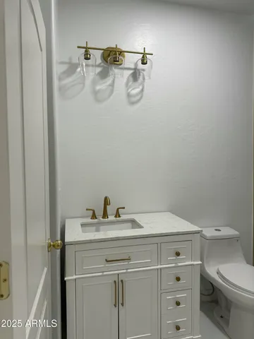 a bathroom with a sink toilet and vanity