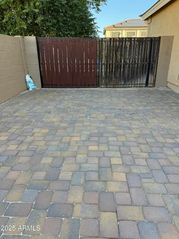 a view of backyard with wooden fence