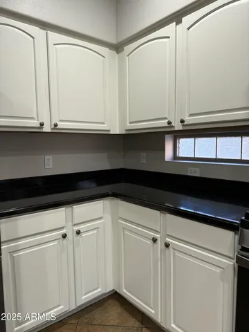 a kitchen with white cabinets and white appliances