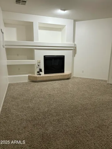 a view of empty room with a fireplace