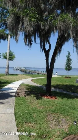 a backyard of a house with yard and outdoor seating