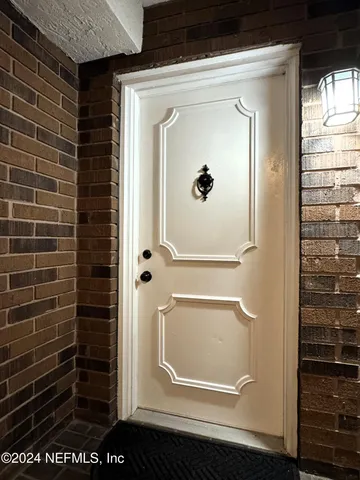 a view of kitchen with stainless steel appliances a sink and a refrigerator