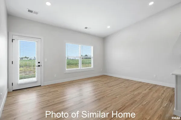 a bed room with a bed mirror and a window