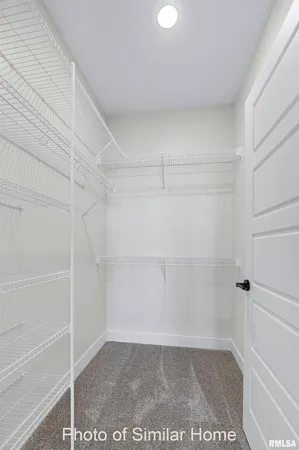 a spacious bathroom with a sink a toilet a mirror and shower