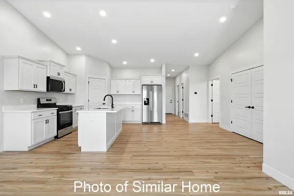 a kitchen with stainless steel appliances a refrigerator sink and microwave