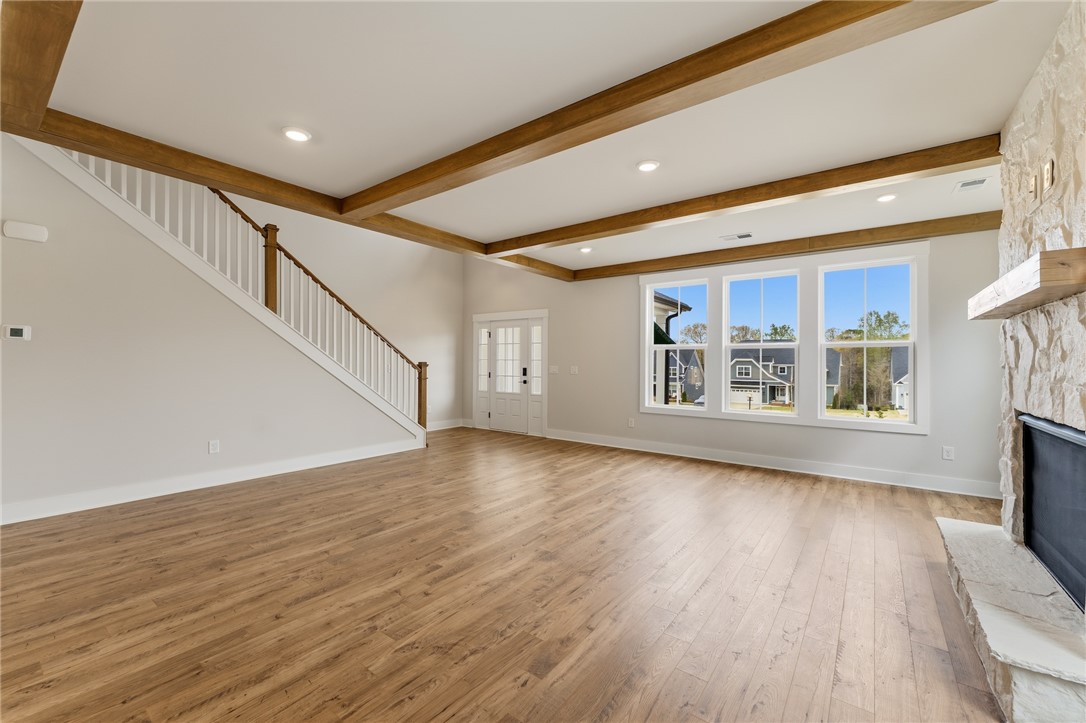 319 Summerall Drive Anderson, SC 29621 - Photo 5 of 37 This living room features rich wood floors, a cozy fireplace, and large windows with abundant natural light.