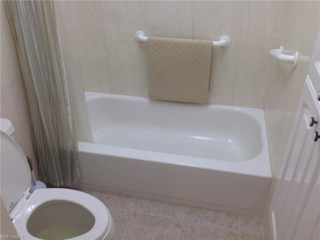 3760 Inverrary Drive, Unit 1W Lauderhill, FL 33319 - Photo 12 of 32 Bathroom featuring toilet and tile patterned floors