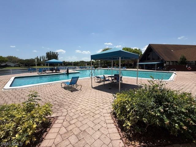 3760 Inverrary Drive, Unit 1W Lauderhill, FL 33319 - Photo 29 of 32 Community pool featuring a gazebo and a patio area