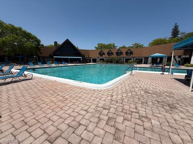3760 Inverrary Drive, Unit 1W Lauderhill, FL 33319 - Photo 30 of 32 Community pool featuring a patio