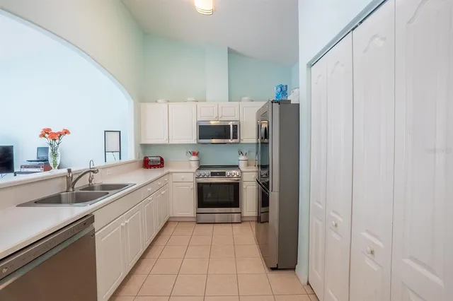 a kitchen with a sink cabinets and stainless steel appliances