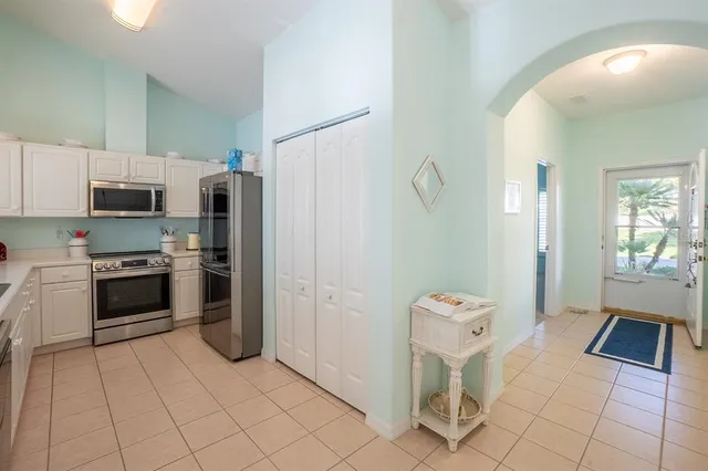 a kitchen with stainless steel appliances granite countertop a refrigerator and a stove top oven