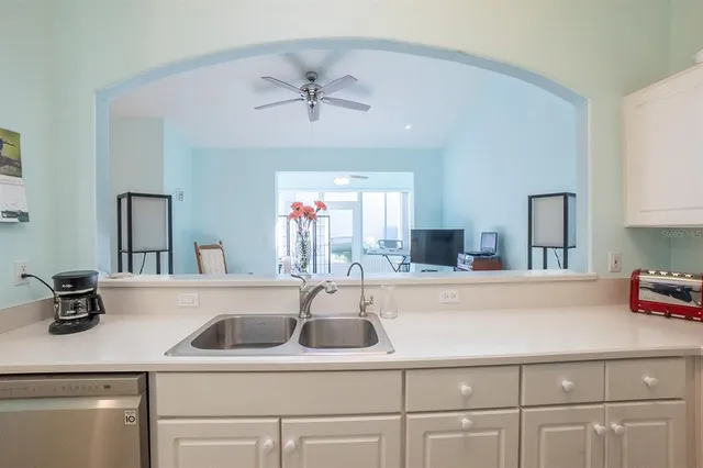 a kitchen with a sink cabinets and window