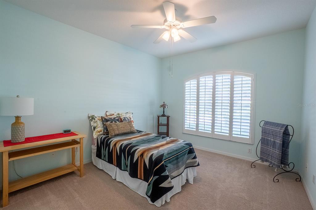 47 Summerwind Circle Palm Coast, FL 32137 - Photo 17 of 32 a bedroom with a bed and a chandelier