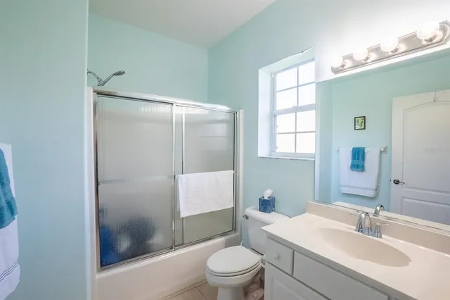 a bedroom with a bed and a chair